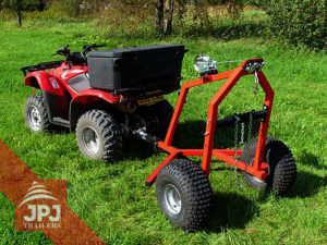 trailer behind small tractor on wood